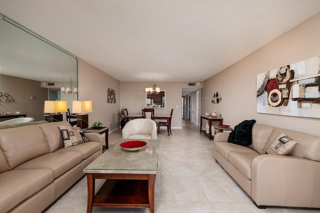 tiled living room with a textured ceiling and a chandelier