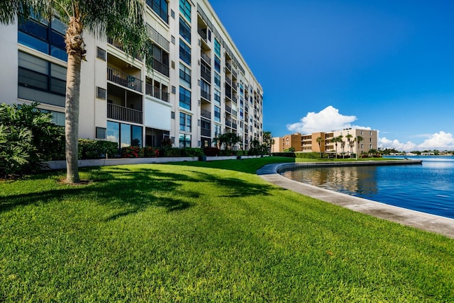 view of home's community featuring a water view and a yard