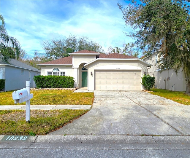 view of front of property with a garage and a front yard