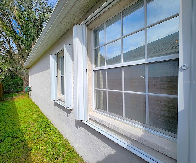 view of side of property with a yard