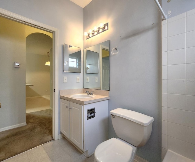 bathroom featuring vanity, tile patterned floors, and toilet