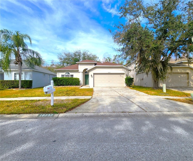 view of front of property with a garage and a front yard