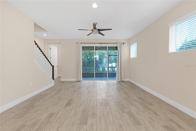 unfurnished living room featuring ceiling fan and light hardwood / wood-style flooring