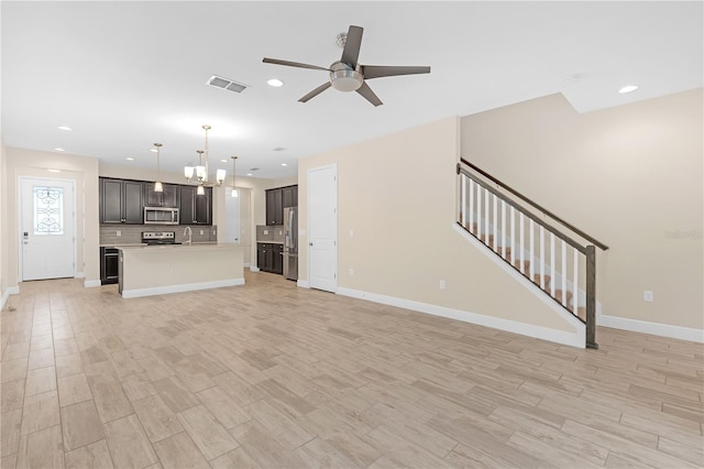 unfurnished living room with ceiling fan, sink, and light hardwood / wood-style flooring