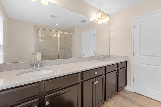 bathroom featuring vanity, wood-type flooring, and an enclosed shower