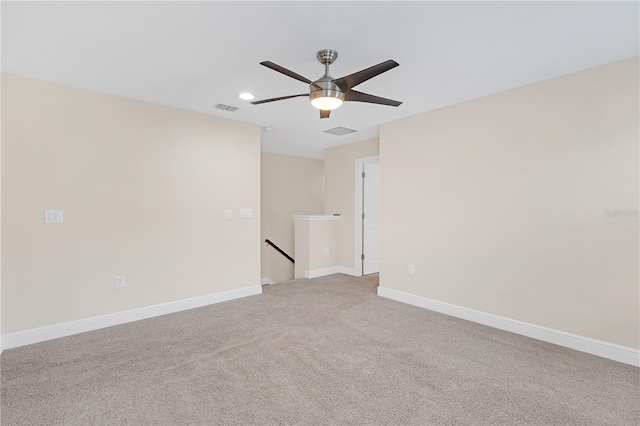 carpeted spare room featuring ceiling fan