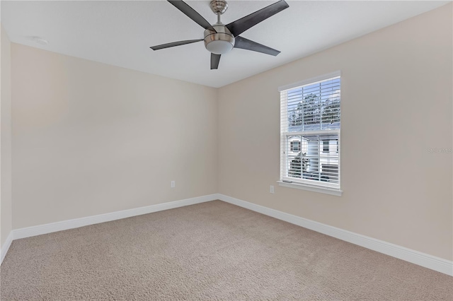 spare room featuring ceiling fan and carpet floors