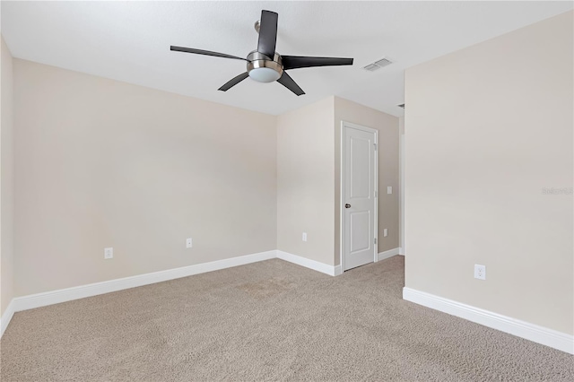 carpeted spare room with ceiling fan