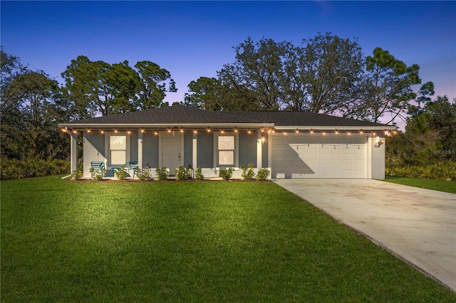 view of front of house featuring a yard, a garage, and covered porch