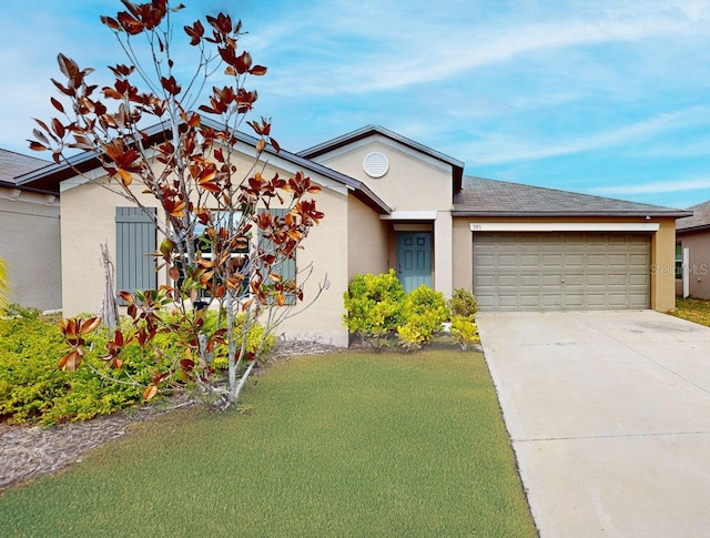 single story home with a garage and a front lawn