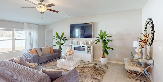 living room featuring lofted ceiling, light tile patterned floors, and ceiling fan