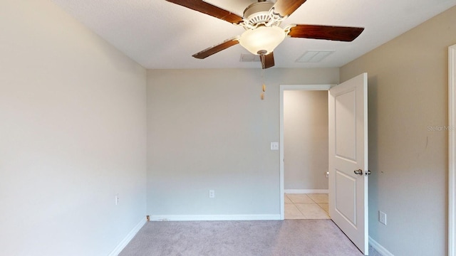 empty room featuring ceiling fan and light carpet