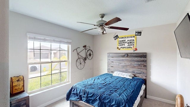 carpeted bedroom with multiple windows and ceiling fan