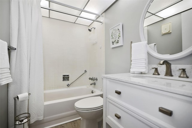 full bathroom featuring hardwood / wood-style flooring, toilet, vanity, and shower / bath combo with shower curtain