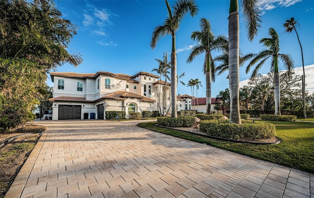 mediterranean / spanish home with a garage