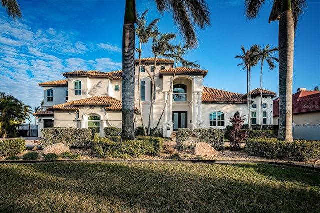 mediterranean / spanish home featuring a front yard