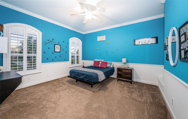 carpeted bedroom with crown molding, ceiling fan, and multiple windows