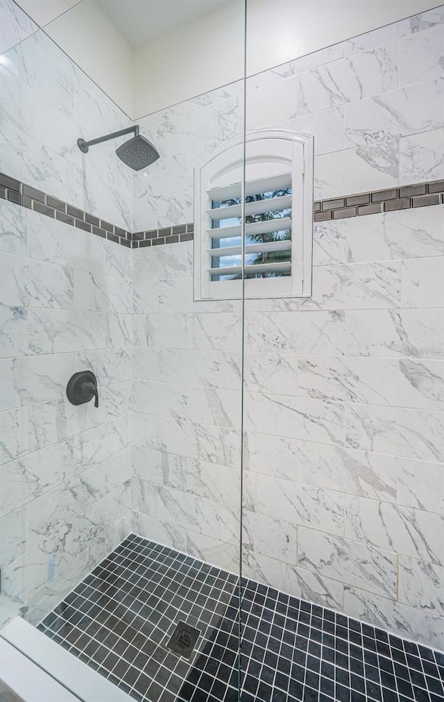 bathroom with tiled shower