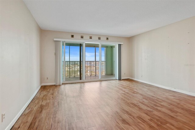 empty room with light hardwood / wood-style flooring