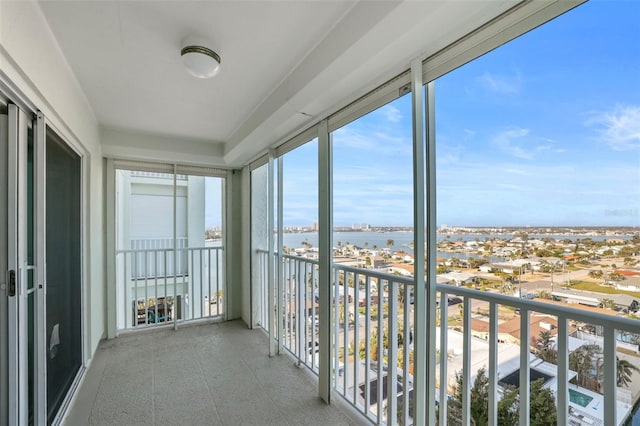 unfurnished sunroom with a water view