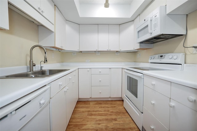 kitchen featuring white appliances, sink, and white cabinets