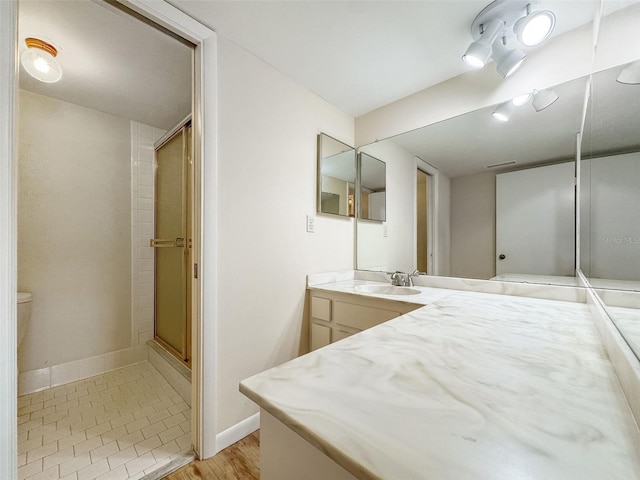 bathroom with vanity and a shower with shower door