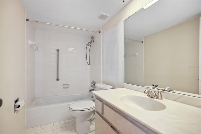 full bathroom featuring tiled shower / bath, tile patterned floors, toilet, and vanity