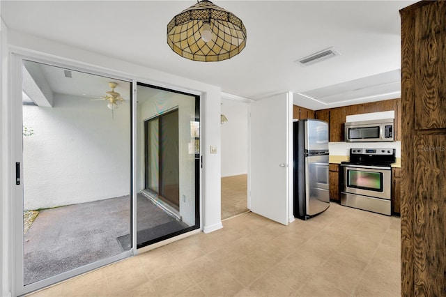 kitchen with ceiling fan and stainless steel appliances