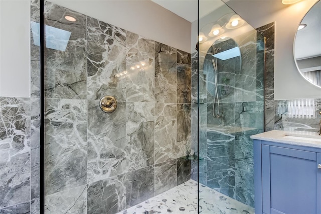 bathroom with vanity and tiled shower