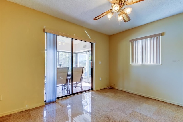 spare room with ceiling fan and a textured ceiling