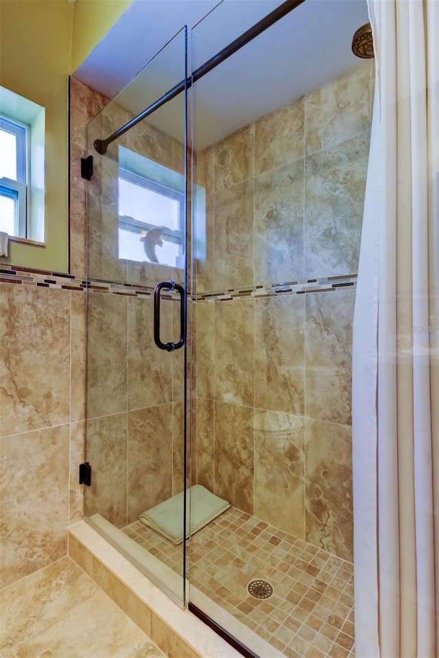 bathroom with a shower with shower door