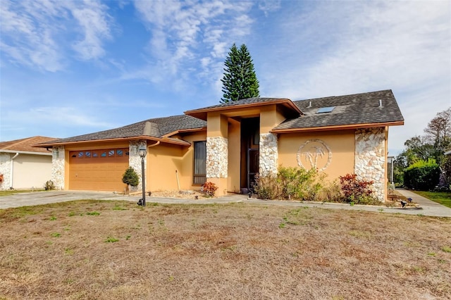 view of front of property featuring concrete driveway, an attached garage, stone siding, and stucco siding