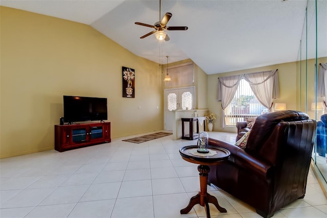 living area featuring tile patterned floors, baseboards, ceiling fan, and vaulted ceiling