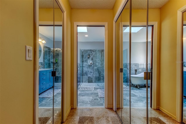 doorway to outside with a textured ceiling
