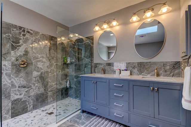 full bath with a sink, marble finish floor, double vanity, and a walk in shower