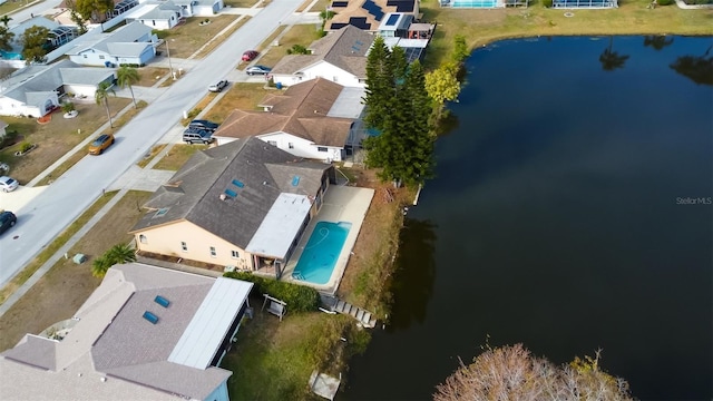 drone / aerial view featuring a water view and a residential view