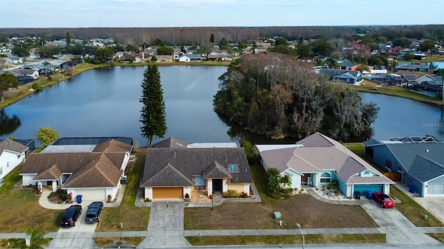drone / aerial view with a residential view and a water view