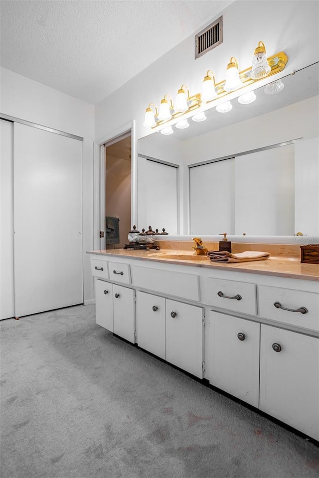 bathroom featuring vanity and a textured ceiling