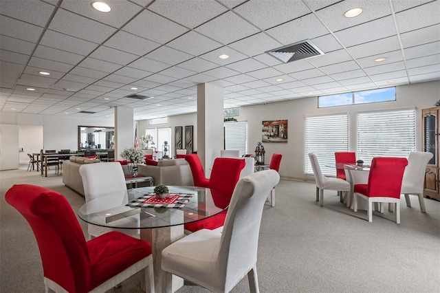 dining room featuring a drop ceiling