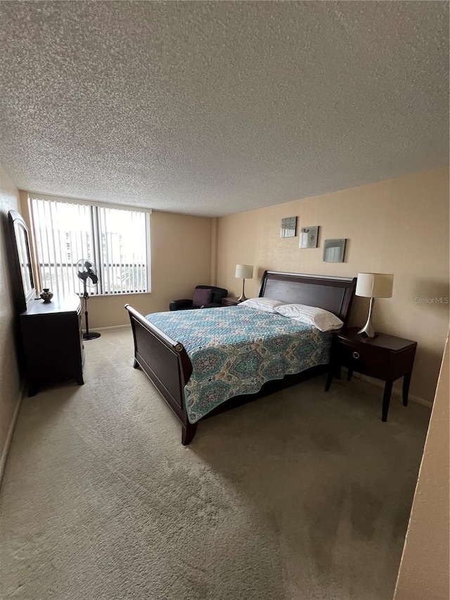 carpeted bedroom with a textured ceiling