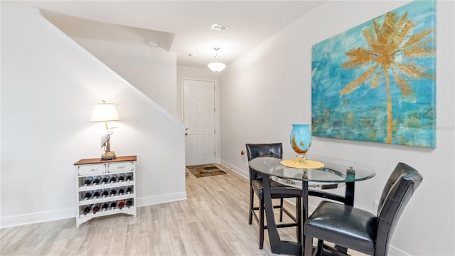 dining space with light hardwood / wood-style flooring