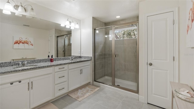 bathroom featuring tile patterned flooring, vanity, and walk in shower