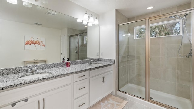 bathroom with vanity, an enclosed shower, and tile patterned floors