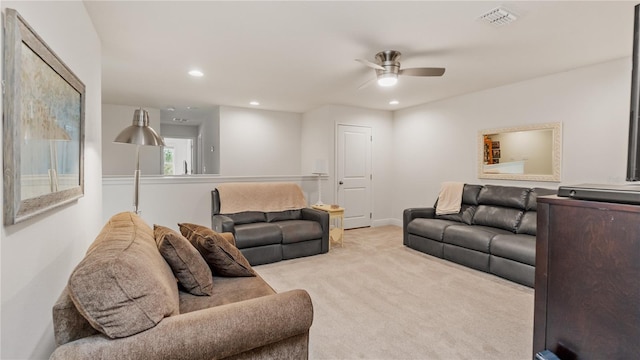 carpeted living room with ceiling fan