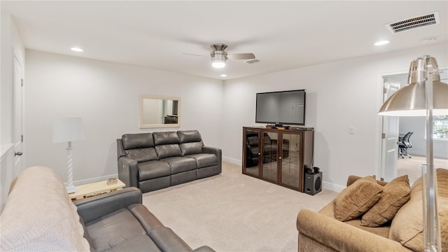 carpeted living room with ceiling fan