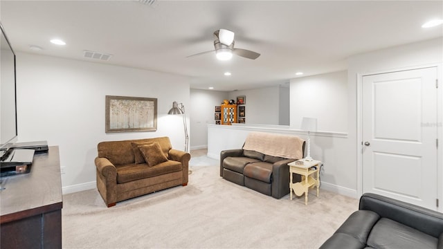 carpeted living room with ceiling fan