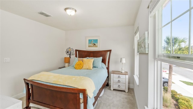 carpeted bedroom featuring multiple windows