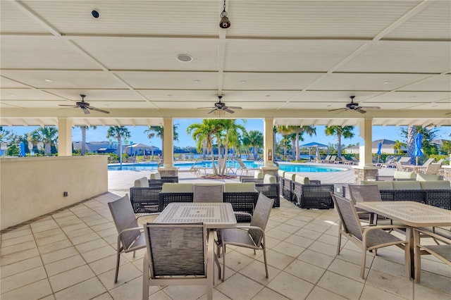 view of patio featuring a community pool and ceiling fan