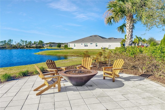 view of patio featuring a fire pit and a water view