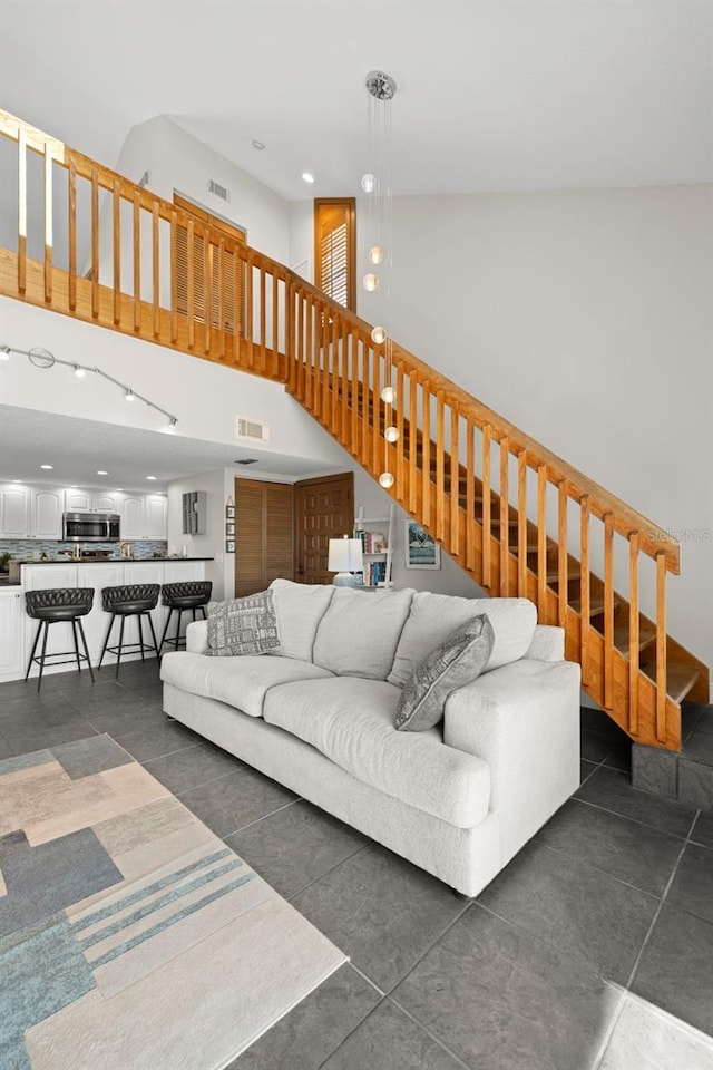 living room featuring a towering ceiling